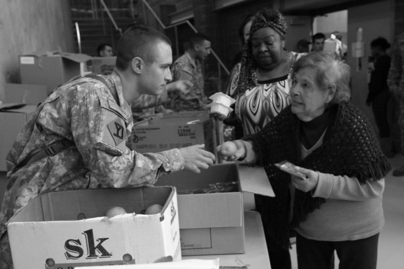 Military Reservist providing victims aid during a crisis