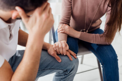Woman Comforting Man In Distress