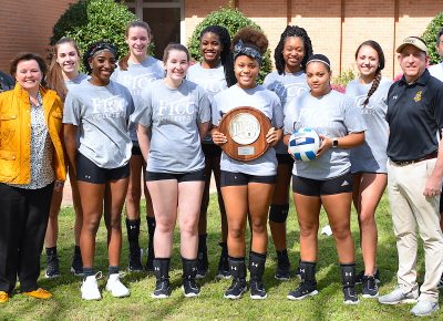 Volleyball team photo with Region 10 runner-up trophy