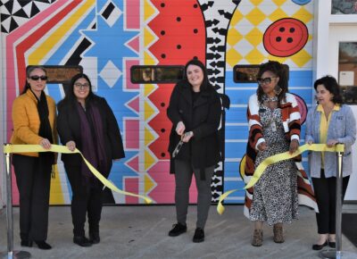 Britney Deveault cuts the ribbon in front of the Success Closet.