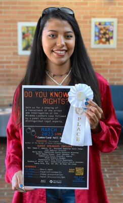 Ashley Gale displays her posters with a white 3rd place ribbon on the corner.