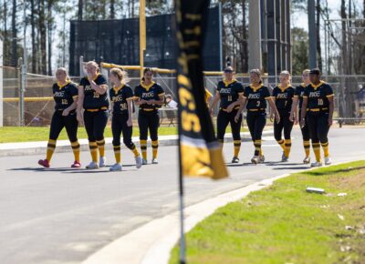 FTCC softball players walk the path to the new softball facility.