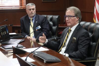 Dr. Mark Sorrells sits at a table and speaks.