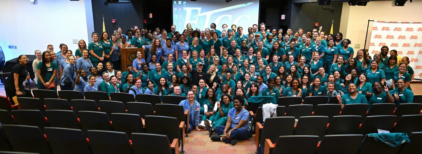A group photo of Nurse Blake, Stephanee Beggs and FTCC Nursing students standing on the Cumberland Hall Auditorium stage.
