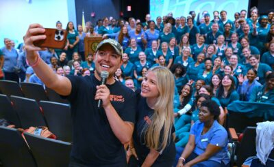 Nurse Blake and Stephanee Beggs take a selfie in front of the audience of FTCC Nursing students.