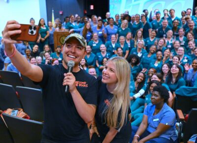 Nurse Blake and Stephanee Beggs take a selfie in front of the audience of FTCC Nursing students.