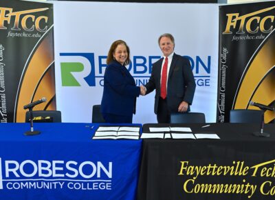 Robeson CC President Melissa Singler Shakes Hands With FTCC President Mark Sorrells