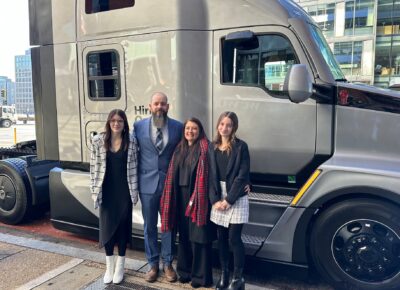 Brandon Meredith and family stand in front of the truck cab he won