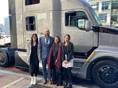 Brandon Meredith and family stand in front of the truck cab he won