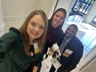 Three people take a selfie.