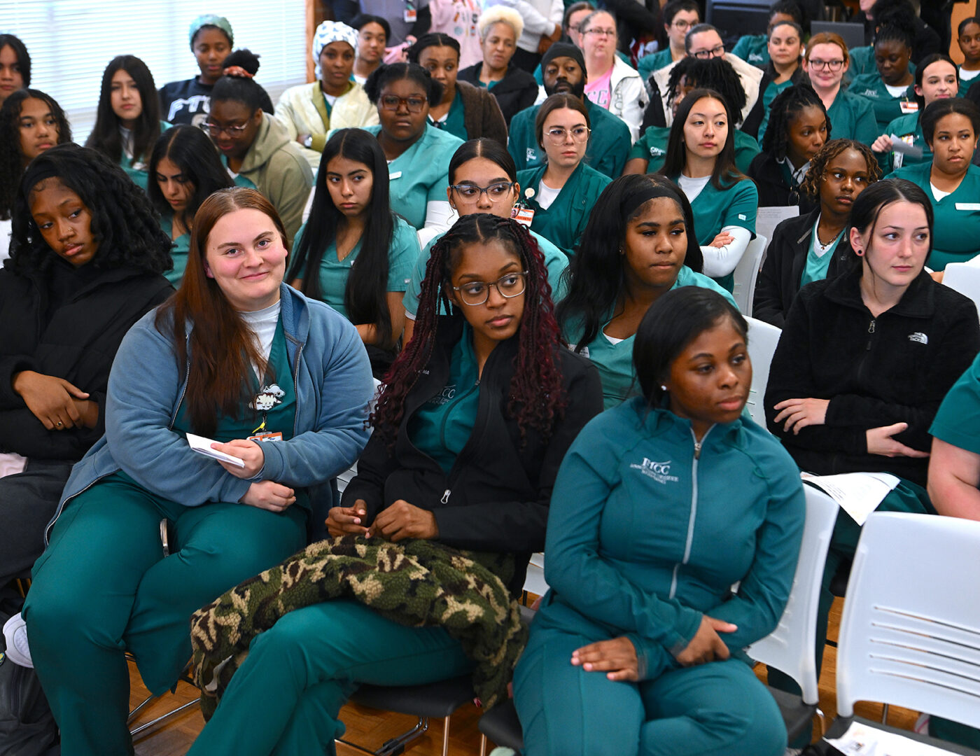 A group of nursing students seated in chairs.