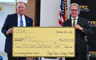 Cape Fear Valley CEO Michael Nagowski and FTCC President Dr. Mark Sorrells with a ceremonial check for CFVH's historic donation to FTCC's Nursing and Allied Health programs.