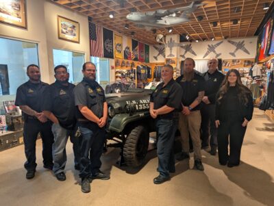 FTCC Restoration Team poses in front of jeep At Airborne & Special Operations Museum