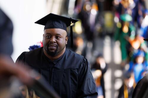 A-graduate-looks-thoughtful-while-waiting-in-line-to-enter-the-Crown