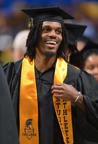 A-graduate-wearing-a-Student-Athlete-stole-smiles-broadly-inside-the-Crown