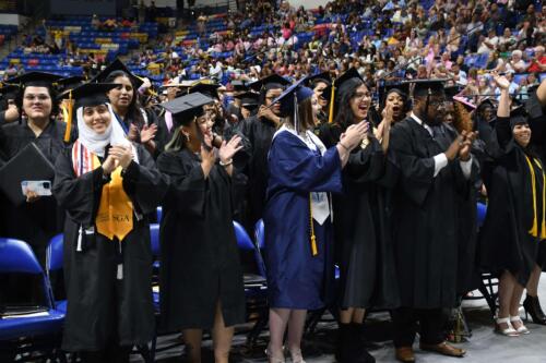 Graduates-stand-on-the-floor-of-the-Crown-and-applaud