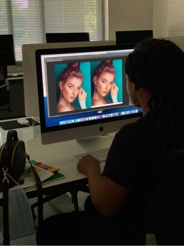 Student sitting at a computer manipulating a picture using graphic design software at FTCC. 