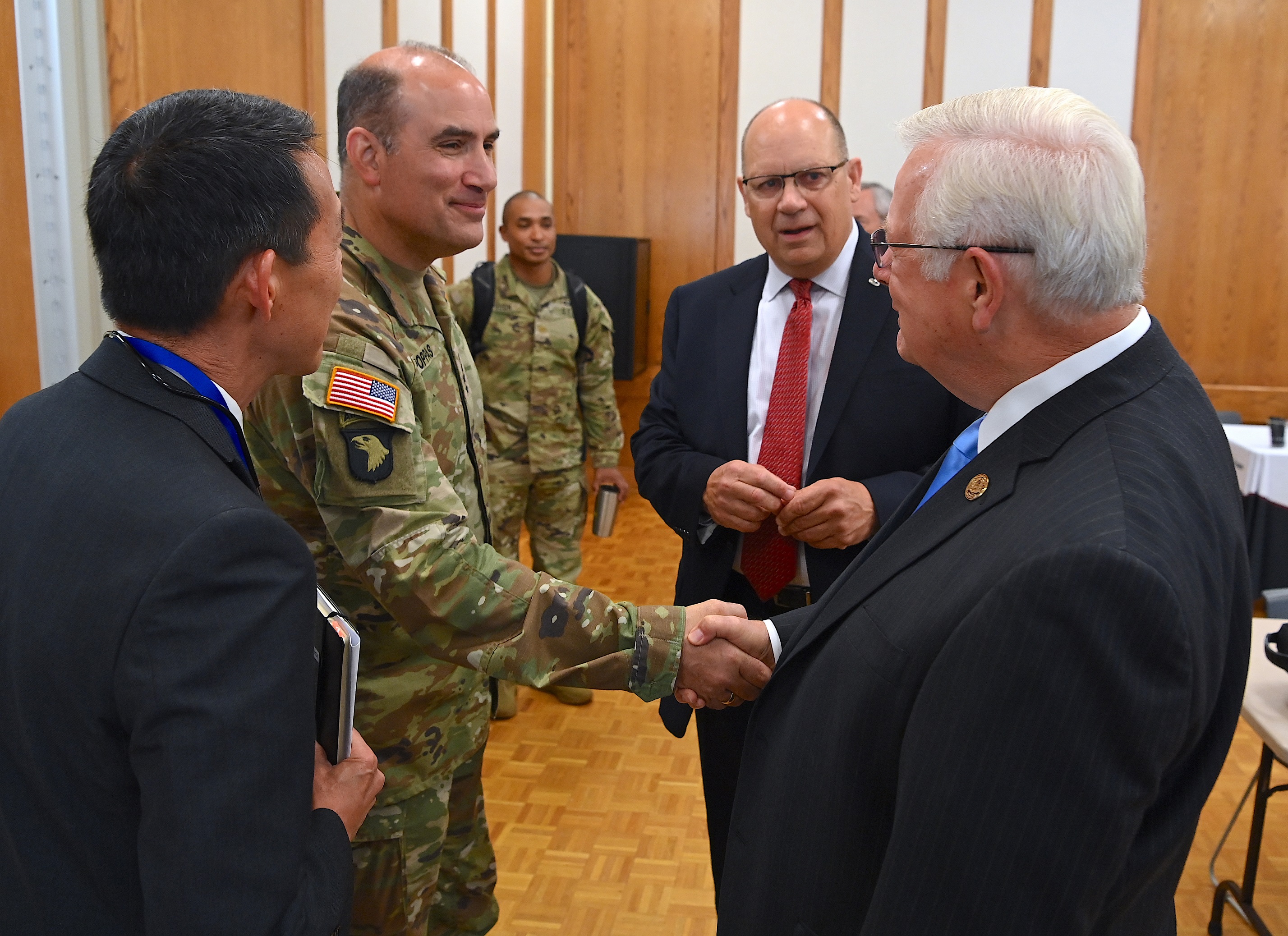 US Forces Command Commanding Gen. Andrew Poppas shakes hands with FTCC President Dr. J. Larry Keen while Dr. Sammy Choi and Scott Dorney look on.