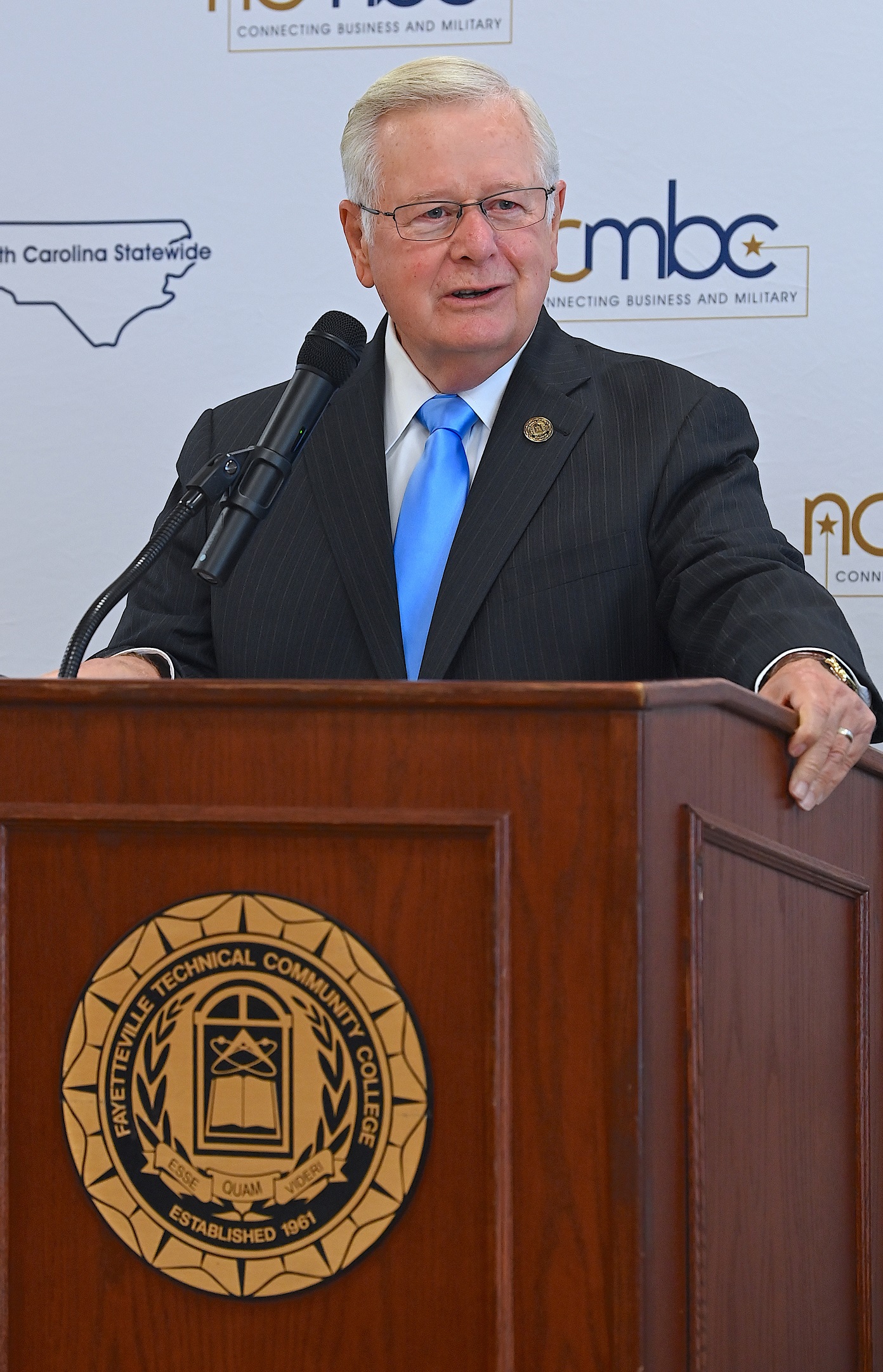 A close-up of FTCC President Dr. J. Larry Keen speaking at the podium.