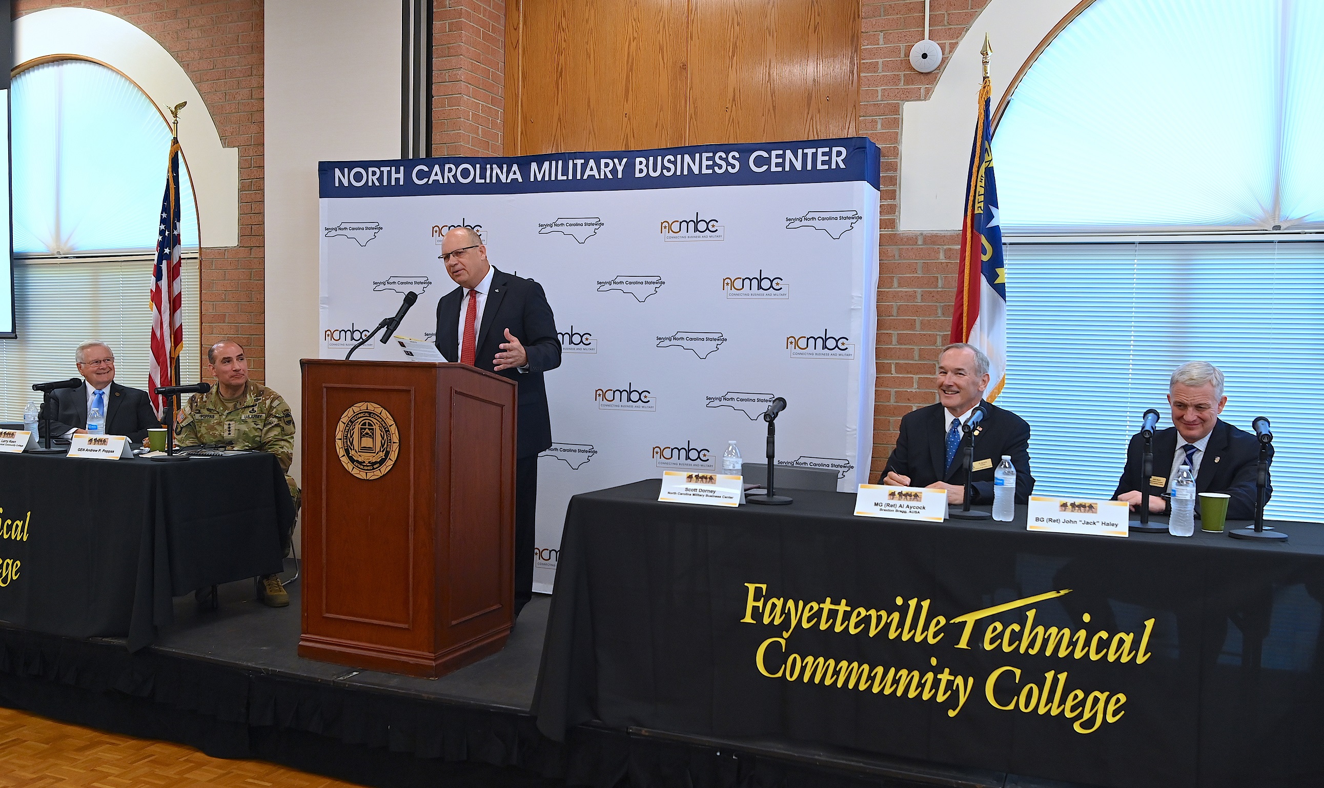 NC Military Business Center executive director Scott Dorney speaks at the podium.