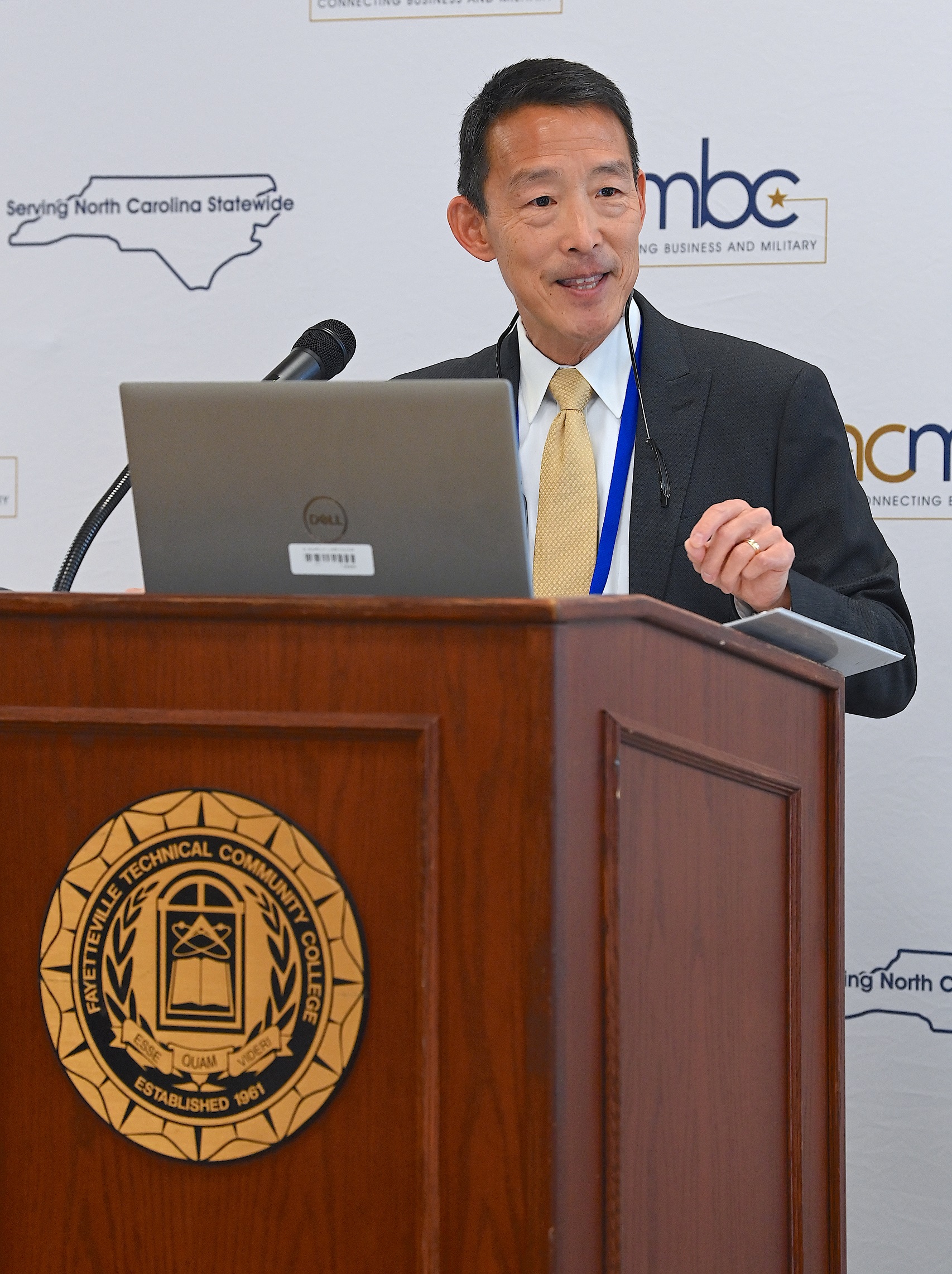 Director of Research for Womack Army Medical Center Dr. Sammy Choi speaks at the podium.
