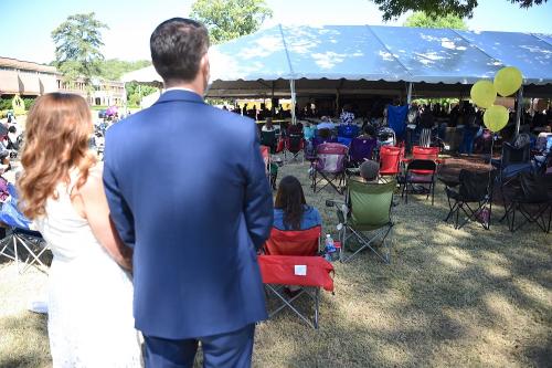 021 - Family and friends watch the ceremony from outside Tent B