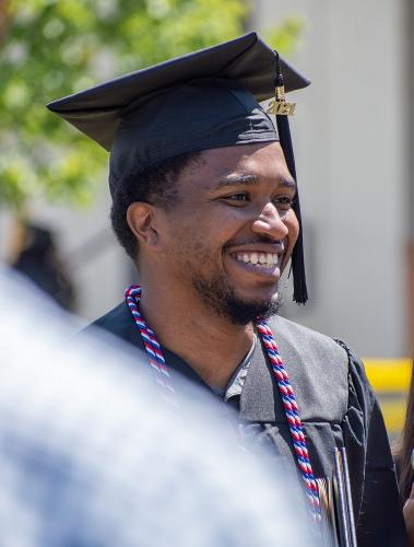 042 - A graduate smiles after the ceremony