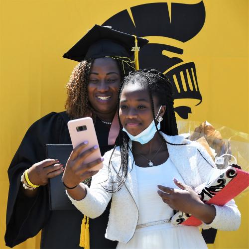 043 - A graduate and a young woman take a selfie