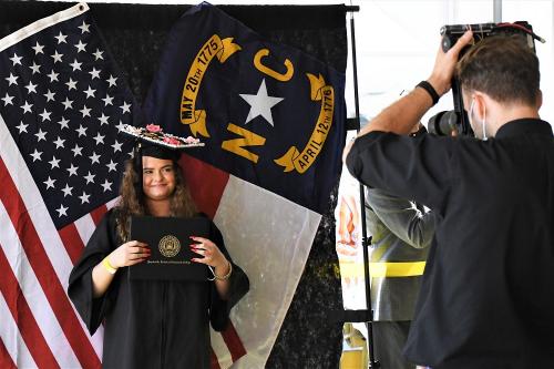 045 - A graduate poses with her diploma cover