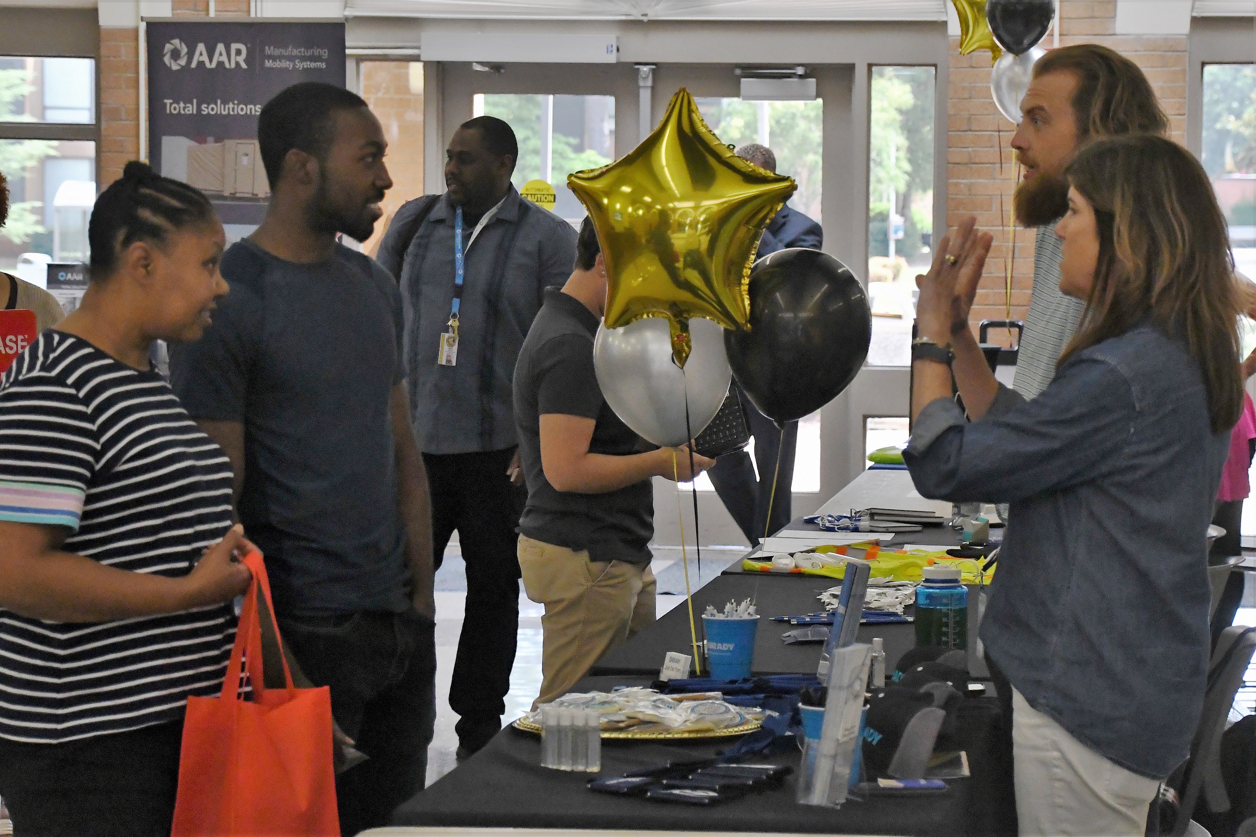 Job seekers talk with employers at the Expo.