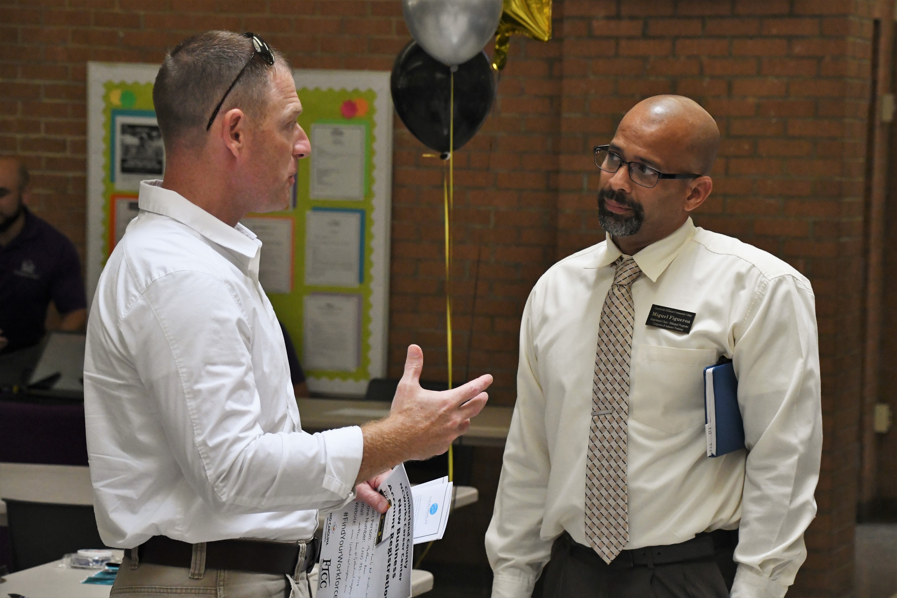 A employer talks with an FTCC staff member at the Expo.