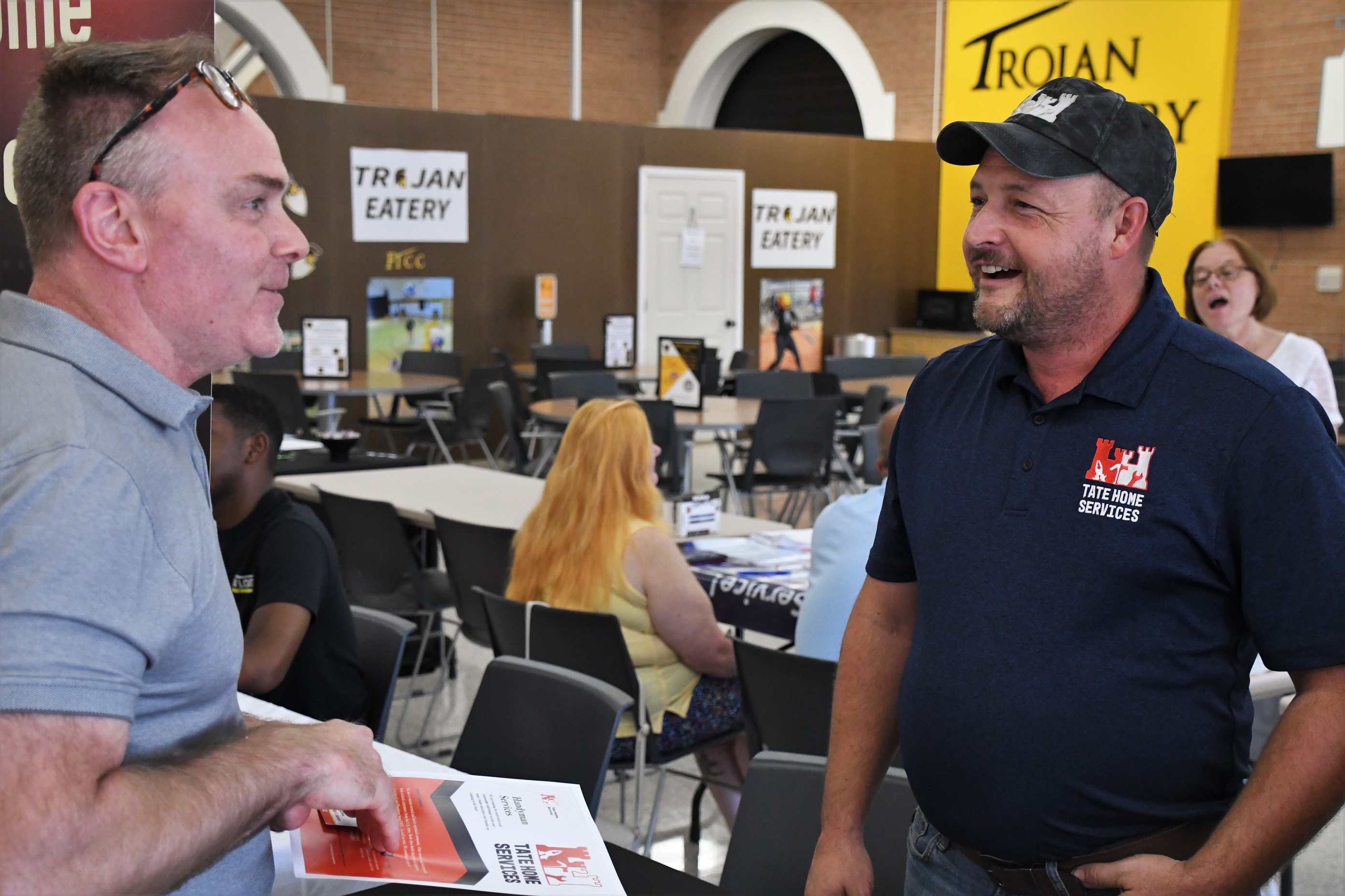 A job seeker and an employer talk at the Expo.