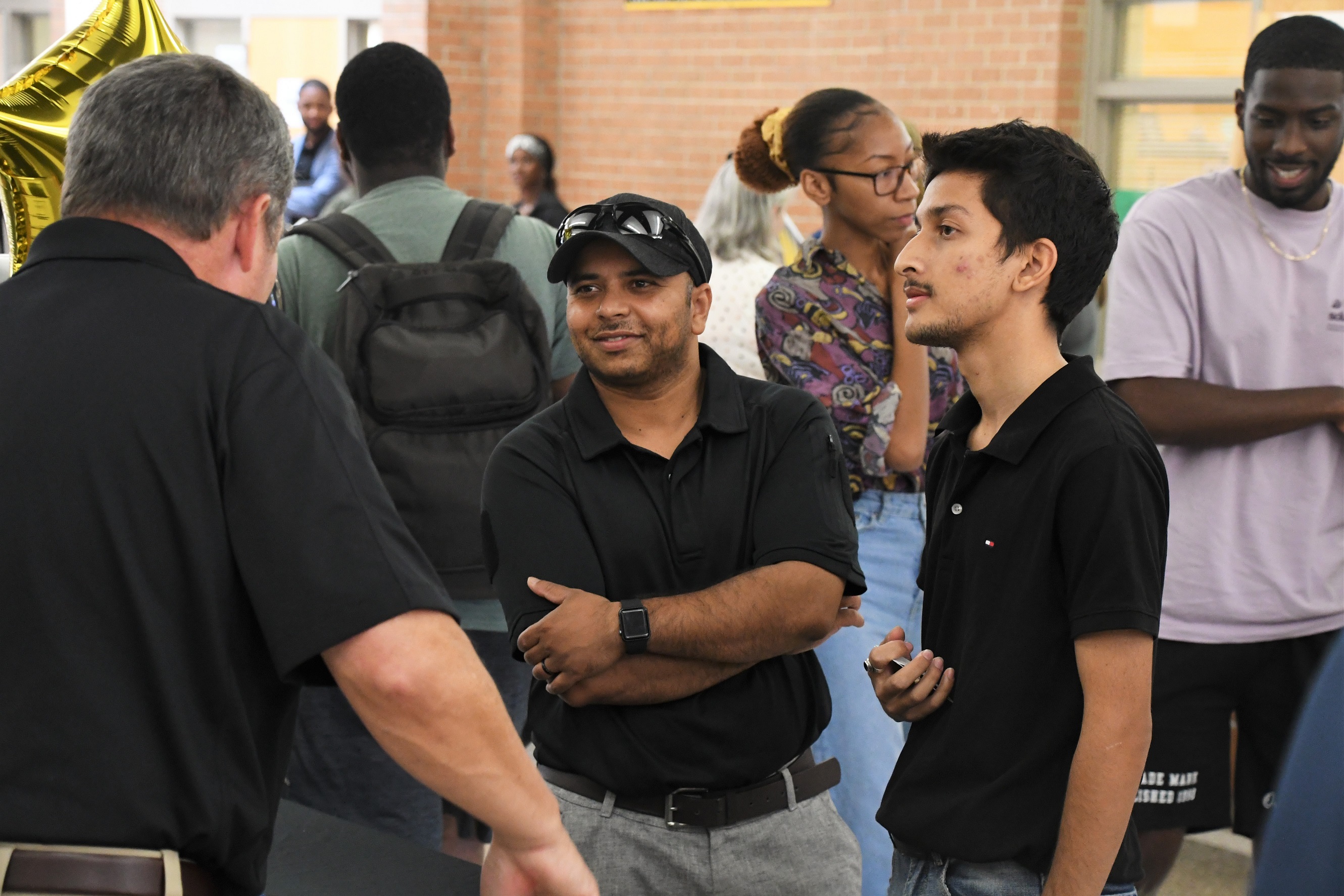 Two attendees talk with an employer at the Skilled Trades and Technology Expo.