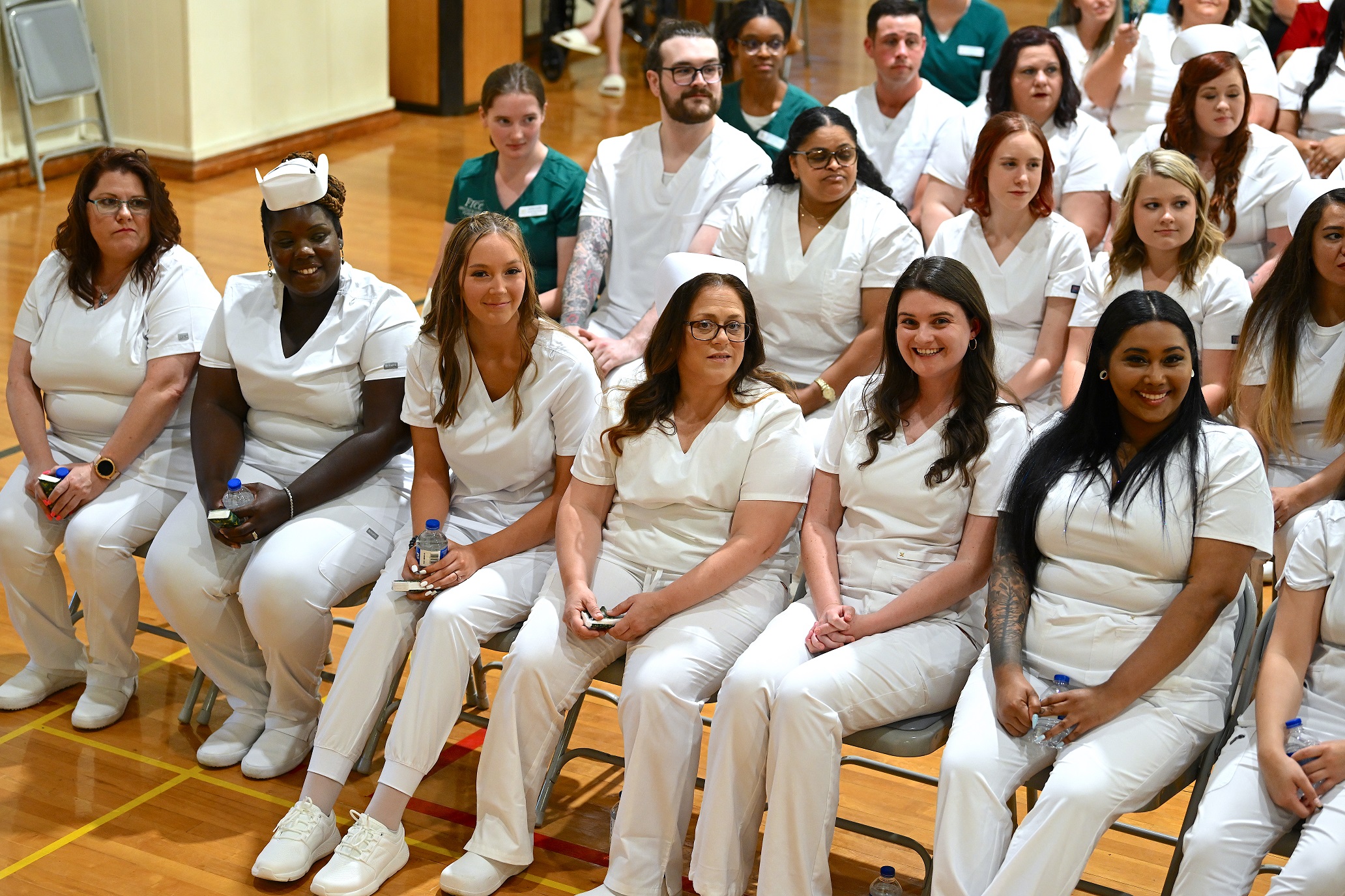 A photo of Nursing graduates seated in rows.