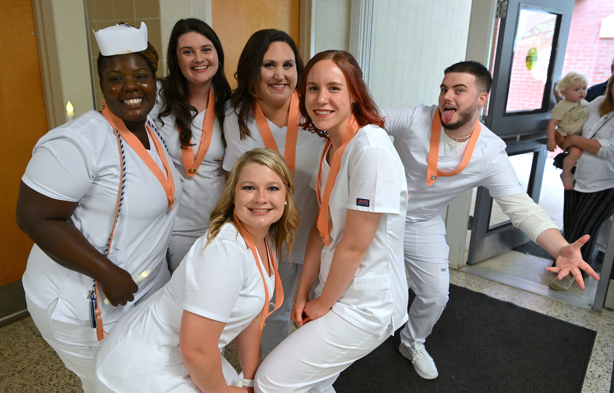 A group of Nursing graduates poses for the camera after graduation.