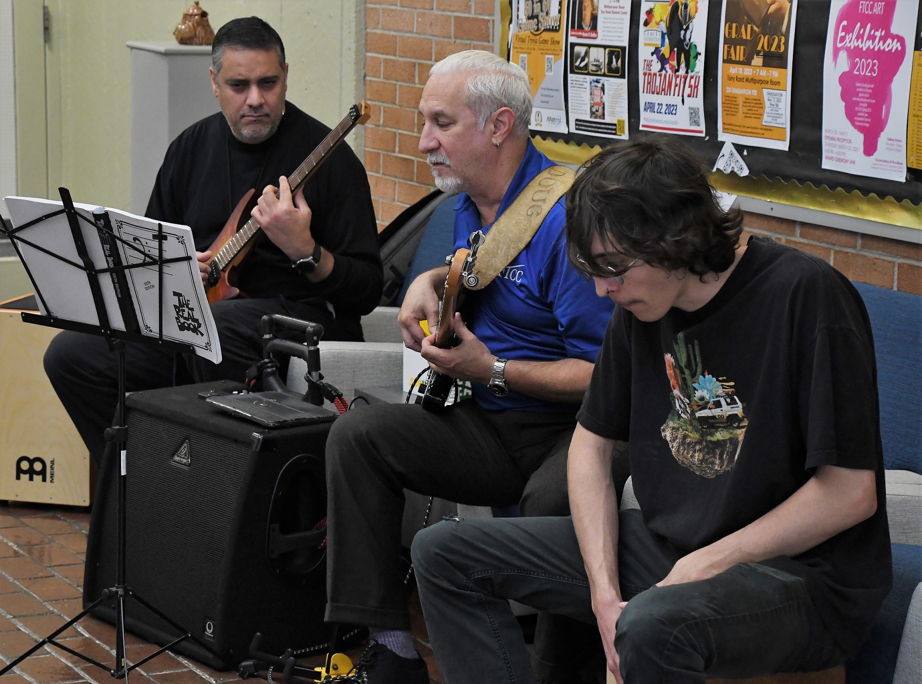 Three musicians play during the art exhibition opening reception.