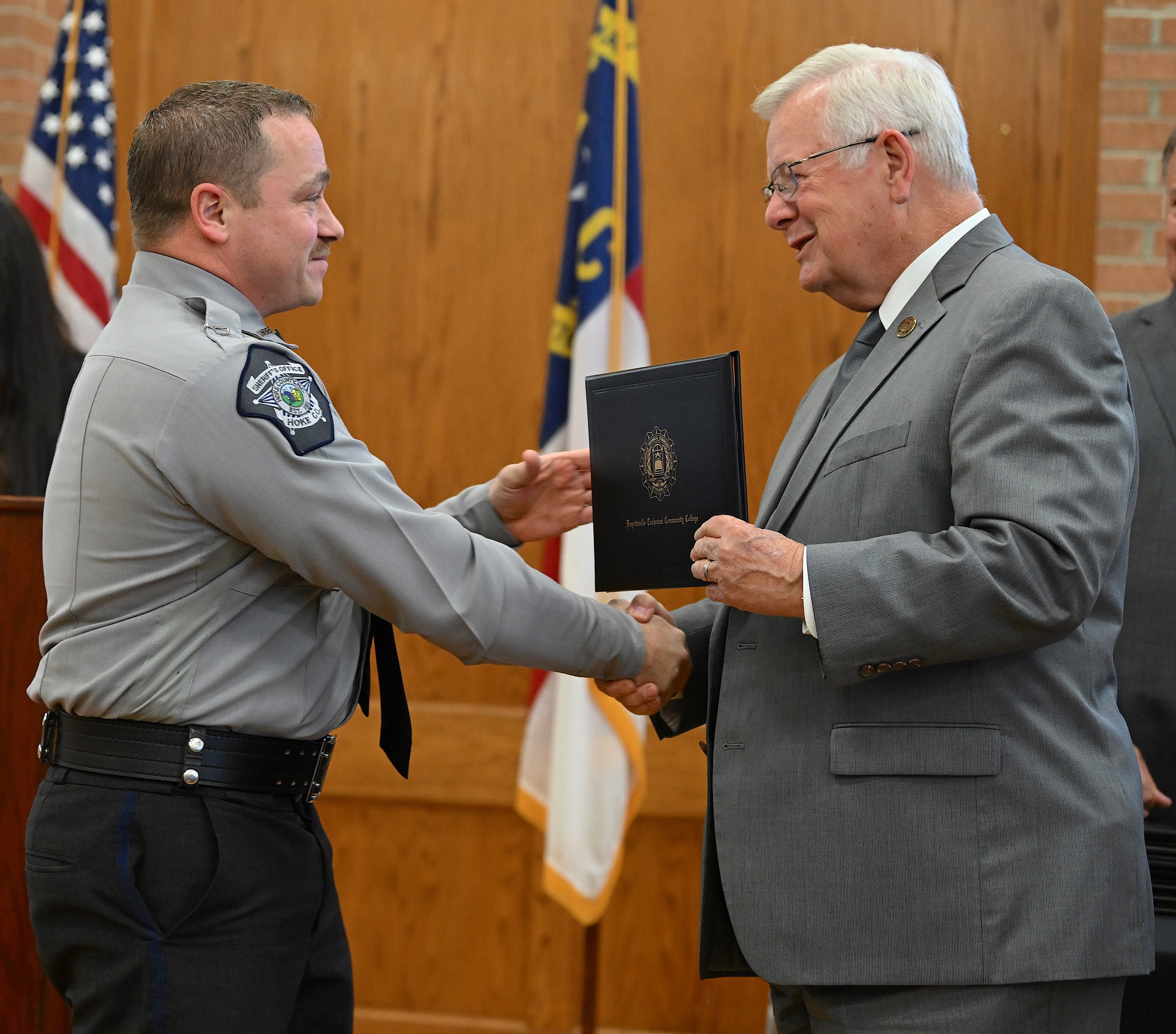 Joshua Marquis accepts his certificate and shakes hands with Dr. Keen.
