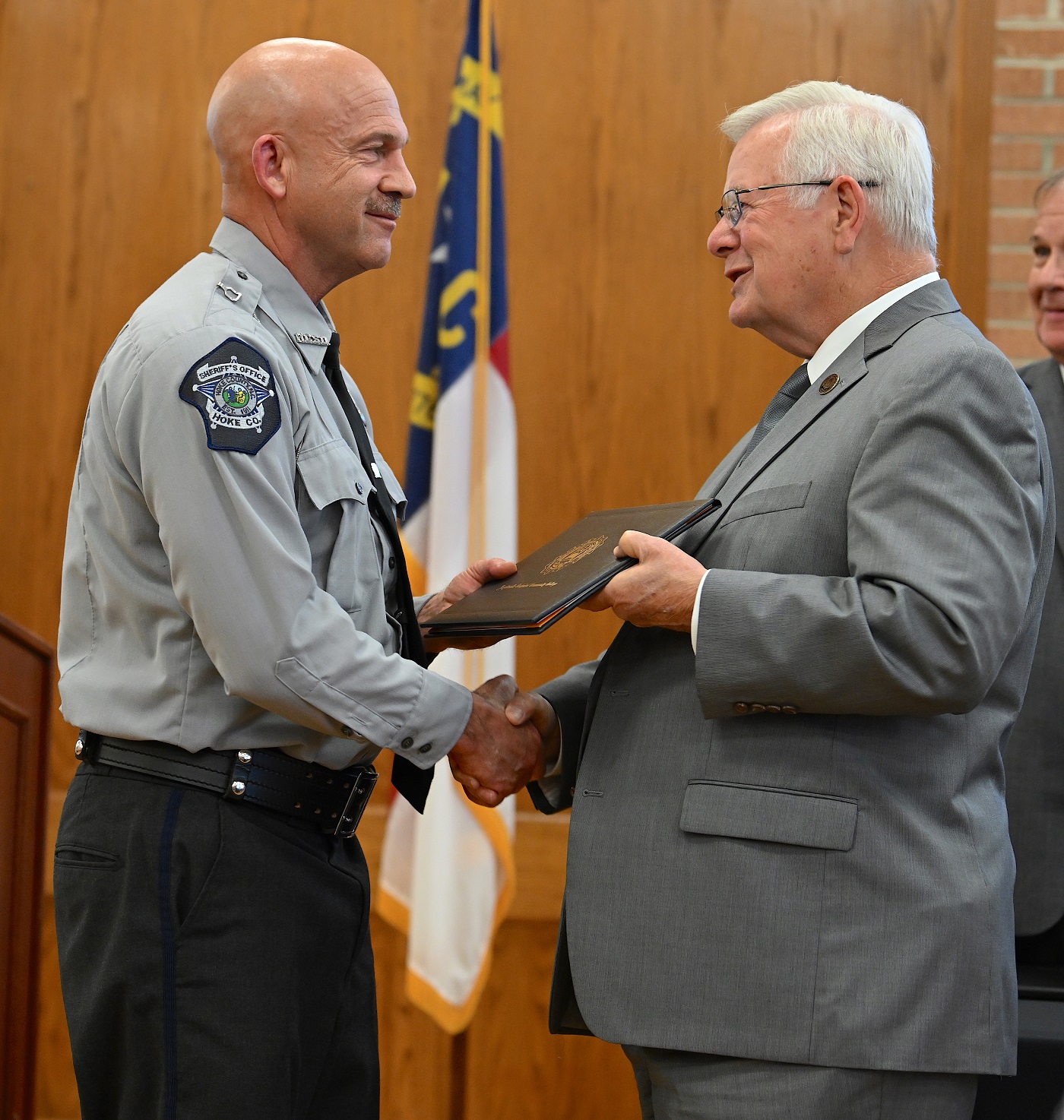 Richard Ward accepts his certificate and shakes hands with Dr. Keen.
