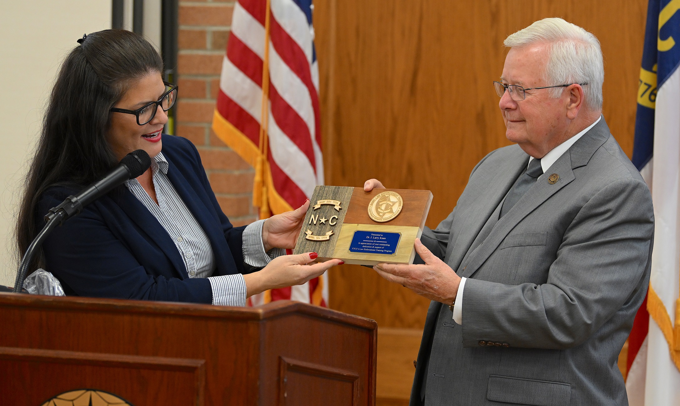 BLET department chair Yovana Vest and Dr. Keen hold a plaque honoring Dr. Keen's support of the training program.