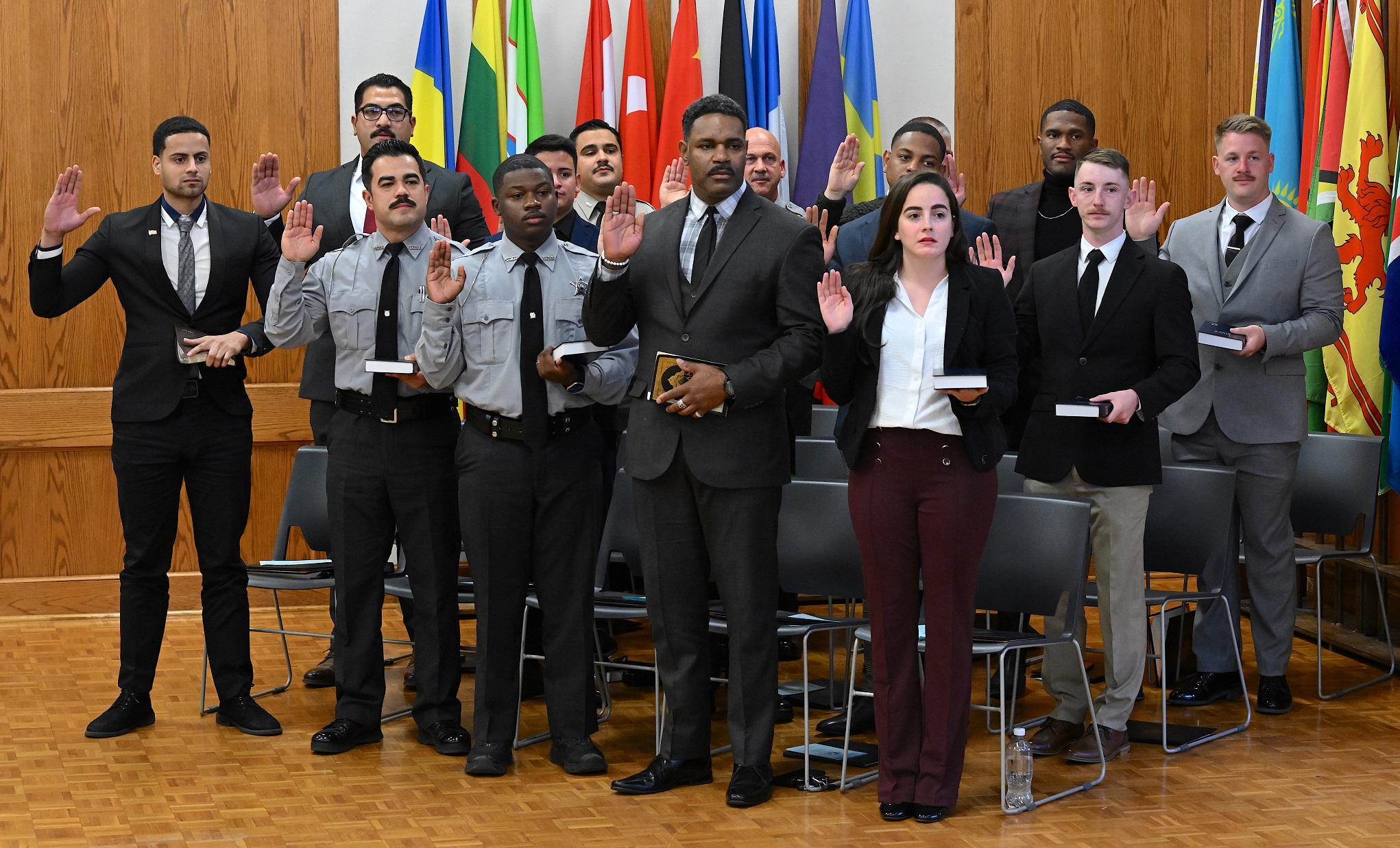 The BLET graduate stand with their right hands raised to swear the oath.