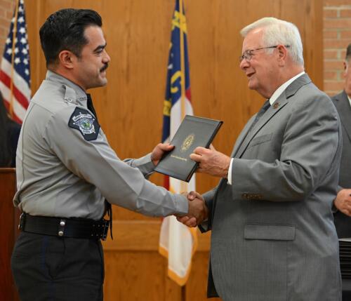 Rene Duvall accepts his certificate and shakes hands with Dr. Keen.