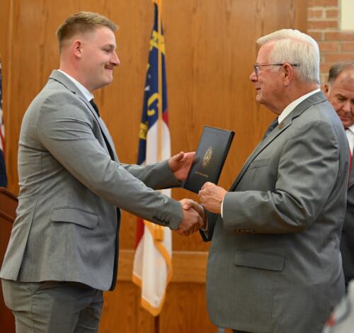 Jacob Rayel accepts his certificate and shakes hands with Dr. Keen.