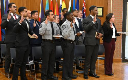 The BLET graduate stand with their right hands raised to swear the oath.