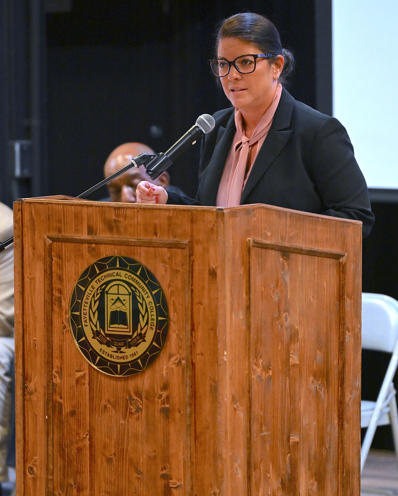 Yovana Vest speaks at the podium.