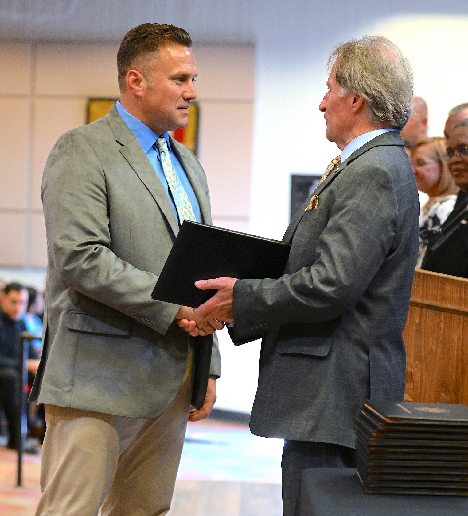 A BLET graduate shakes hands with Dr. Sorrells before receiving his certificate.