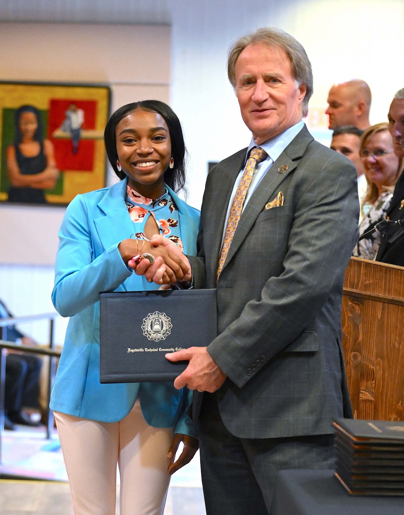 A BLET graduate poses with Dr. Sorrells after receiving her certificate.