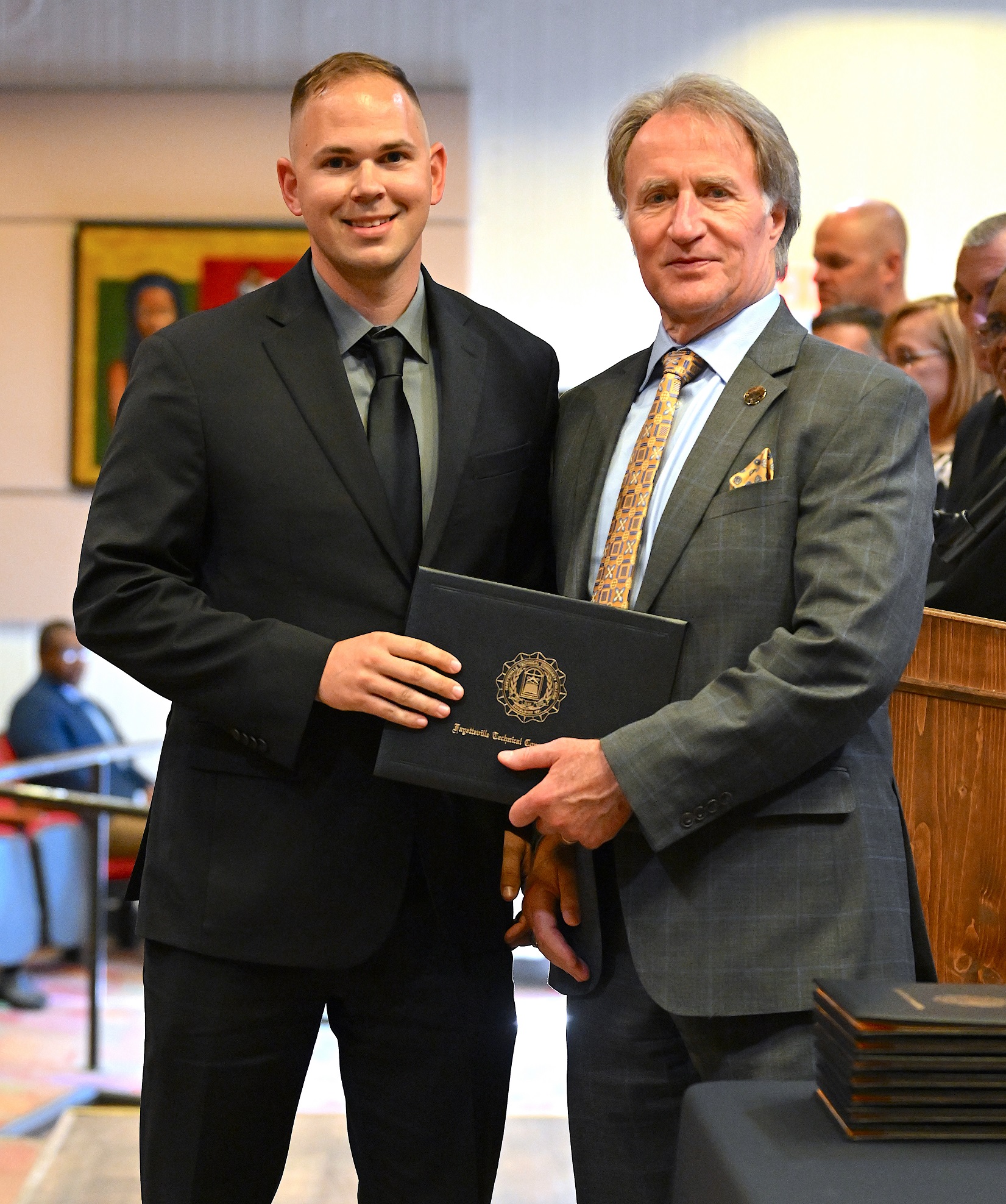 A BLET graduate poses with Dr. Sorrells after receiving his certificate.