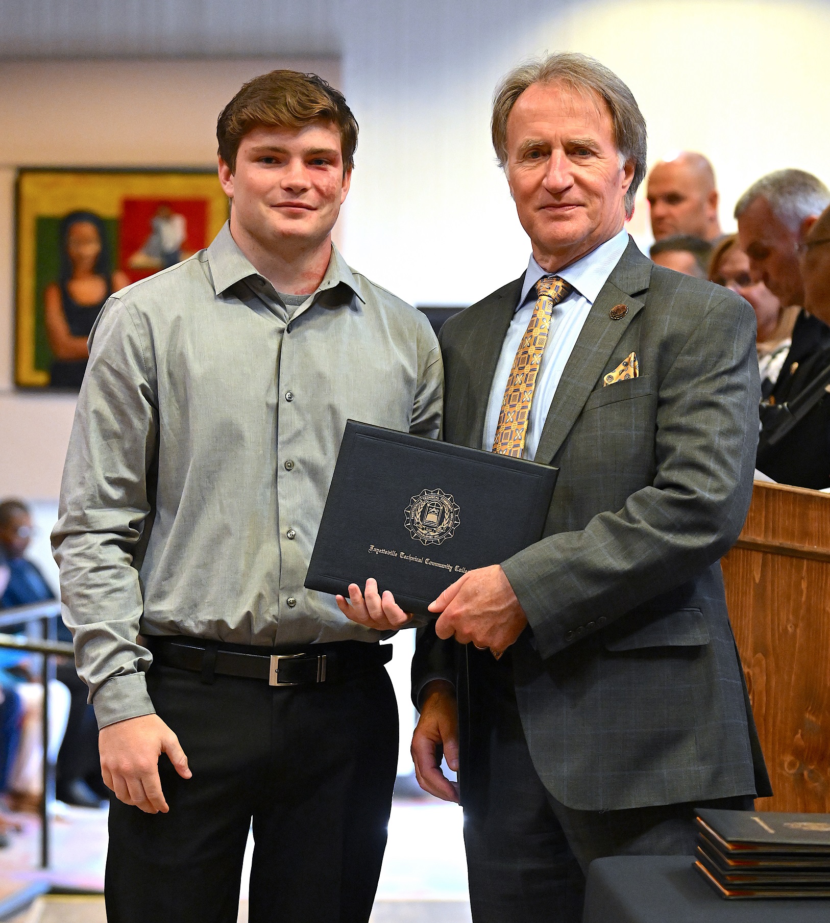 A BLET graduate poses with Dr. Sorrells after receiving his certificate.