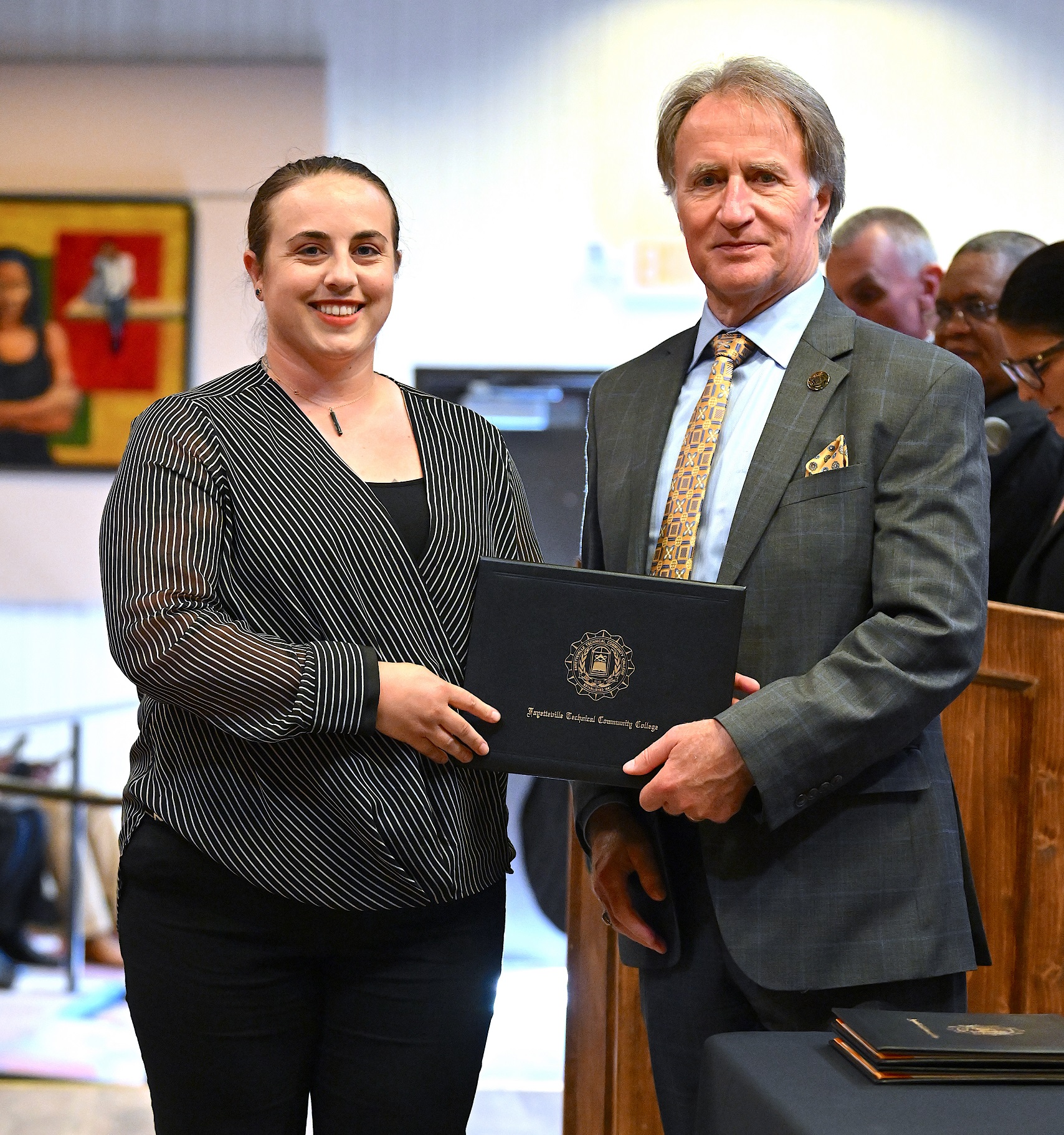A BLET graduate poses with Dr. Sorrells after receiving her certificate.