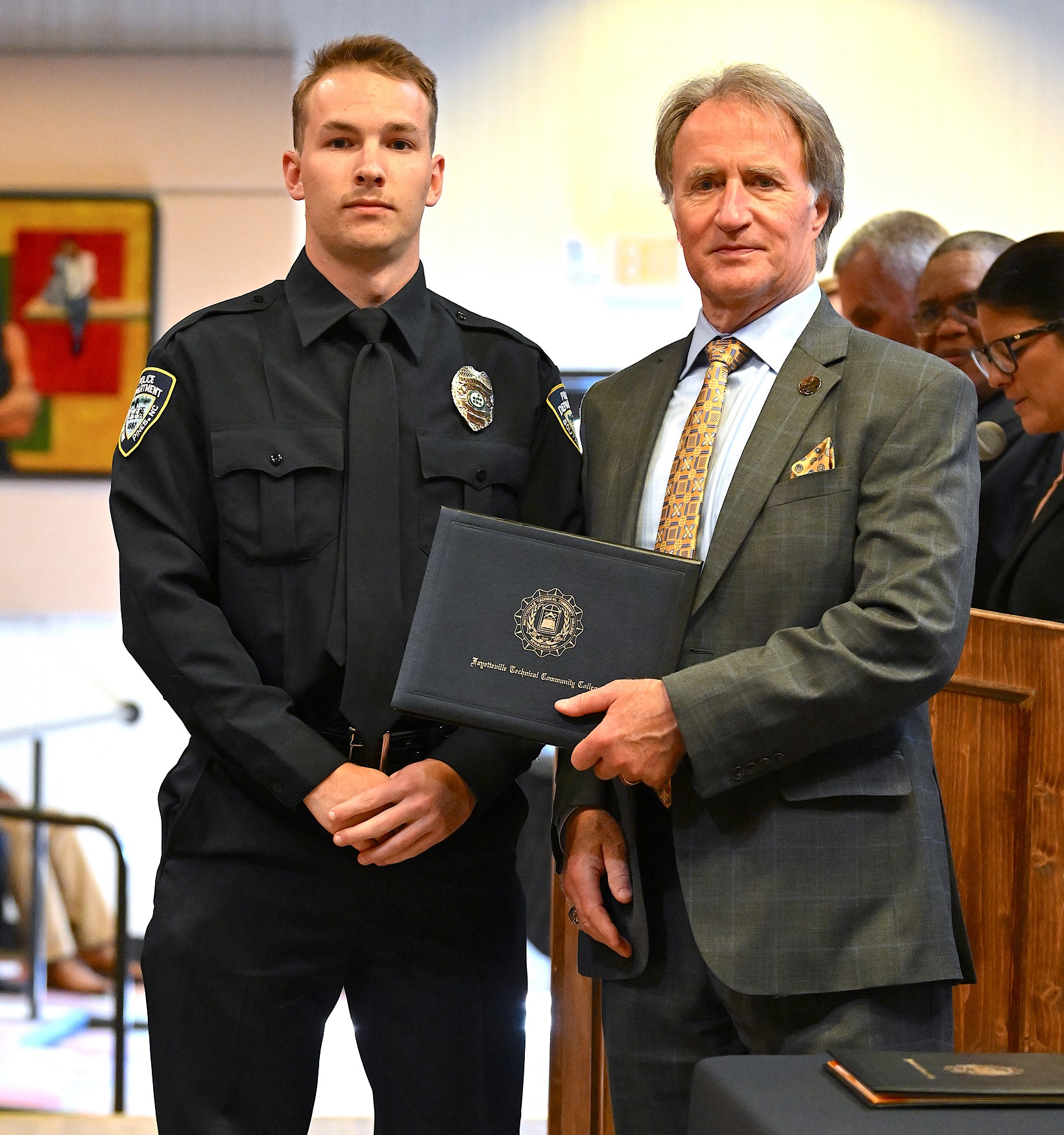 A BLET graduate poses with Dr. Sorrells after receiving his certificate.